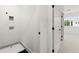 Neat laundry area with washer/dryer hookups and adjacent to a carpeted room at 654 Soul Aly # 102, Alpharetta, GA 30009