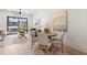 Open-concept living space with a dining area features a large window, hardwood floors, and contemporary decor at 654 Soul Aly # 102, Alpharetta, GA 30009