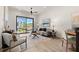 Bright living room with comfortable seating, a large window, modern decor, and hardwood floors throughout at 654 Soul Aly # 102, Alpharetta, GA 30009