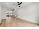 Spacious living room with hardwood floors, stairs, and modern railings at 654 Soul Aly # 102, Alpharetta, GA 30009
