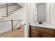 Stylish powder room with modern fixtures, a wood vanity, and a decorative mirror at 654 Soul Aly # 102, Alpharetta, GA 30009