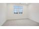 Bright bedroom with large window, neutral carpet, and recessed lighting offers a cozy and inviting space at 654 Soul Aly # 102, Alpharetta, GA 30009