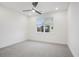 Minimalist bedroom with a ceiling fan, carpet, and window at 654 Soul Aly # 102, Alpharetta, GA 30009