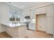 Modern kitchen boasts white cabinetry, quartz countertops, and stainless steel appliances at 654 Soul Aly # 102, Alpharetta, GA 30009