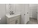 Bathroom featuring modern vanity, sink, faucet, mirror, and a door to a walk in closet at 673 Soul Aly # 146, Alpharetta, GA 30009