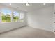 Bright bedroom with three large windows and neutral-colored carpet at 673 Soul Aly # 146, Alpharetta, GA 30009