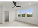 Bright bedroom with carpet, black ceiling fan, recessed lighting, and large windows offering a view at 673 Soul Aly # 146, Alpharetta, GA 30009