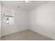 Small bedroom features neutral walls and carpet, a window, and white baseboards at 673 Soul Aly # 146, Alpharetta, GA 30009