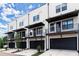 Modern townhomes with black accents, private balconies, and attached garages offer stylish urban living at 673 Soul Aly # 146, Alpharetta, GA 30009