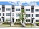 Modern townhome exterior features white brick, black window frames, and professionally landscaped front yard at 673 Soul Aly # 146, Alpharetta, GA 30009