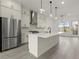 Spacious kitchen features a large island, stainless steel appliances, and modern pendant lighting at 673 Soul Aly # 146, Alpharetta, GA 30009