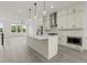 Bright kitchen featuring an island, modern cabinets, stainless steel appliances, and hard surface flooring at 673 Soul Aly # 146, Alpharetta, GA 30009