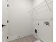 Clean, bright laundry room with modern appliances hookups and shelving for organized storage solutions at 673 Soul Aly # 146, Alpharetta, GA 30009