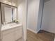 Bathroom featuring white vanity with sink, white cabinetry, and modern fixtures at 673 Soul Aly # 146, Alpharetta, GA 30009