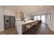Stylish kitchen featuring a spacious island with seating, modern pendant lighting, and stainless steel refrigerator at 673 Soul Aly # 146, Alpharetta, GA 30009
