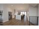Open-concept kitchen with a large island, stainless steel appliances, and hardwood flooring at 673 Soul Aly # 146, Alpharetta, GA 30009