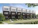 Contemporary townhomes showcase a black facade, dark trim, and manicured front yards, creating a sleek look at 673 Soul Aly # 146, Alpharetta, GA 30009
