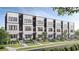 Modern townhomes feature a light gray facade, black trim, and landscaped front yards for curb appeal at 673 Soul Aly # 146, Alpharetta, GA 30009