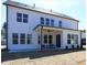 Modern farmhouse exterior with large windows, covered patio, and spacious backyard at 3548 Cedarvale Ct, Powder Springs, GA 30127