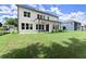 A view of a large backyard and patio with lush green grass, perfect for outdoor activities at 3548 Cedarvale Ct, Powder Springs, GA 30127