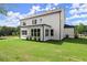 A view of the backyard that features a well maintained yard and covered patio at 3548 Cedarvale Ct, Powder Springs, GA 30127