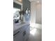 Bathroom with a window and a tub and shower combo, featuring neutral wall paint and elegant decor at 3548 Cedarvale Ct, Powder Springs, GA 30127