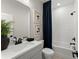 Modern bathroom featuring a white vanity, subway tile shower, and contemporary fixtures at 3548 Cedarvale Ct, Powder Springs, GA 30127