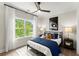 Cozy bedroom with a comfortable bed, natural light, and baseball-themed decor at 3548 Cedarvale Ct, Powder Springs, GA 30127