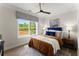 Cozy bedroom featuring a comfortable bed, soft rug, and bright window views at 3548 Cedarvale Ct, Powder Springs, GA 30127