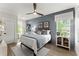 Serene bedroom with wood accents and a large window that brings in natural light at 3548 Cedarvale Ct, Powder Springs, GA 30127