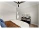 Bedroom showcasing a console table, wood floors and ensuite bathroom entrance at 3548 Cedarvale Ct, Powder Springs, GA 30127