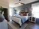 Bright bedroom with blue accent wall, ceiling fan, and neutral furniture at 3548 Cedarvale Ct, Powder Springs, GA 30127