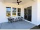 Cozy covered patio with seating, a ceiling fan, and view of the backyard at 3548 Cedarvale Ct, Powder Springs, GA 30127