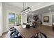 Open dining room with large windows, modern lighting, and access to outdoor patio at 3548 Cedarvale Ct, Powder Springs, GA 30127