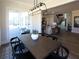 Dining room with modern lighting fixture, seating for six, and access to the patio at 3548 Cedarvale Ct, Powder Springs, GA 30127