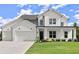 Beautiful two-story home featuring white brick, siding, a three-car garage, and a green lawn at 3548 Cedarvale Ct, Powder Springs, GA 30127
