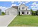 Stunning two-story home with white brick, siding, three-car garage, and well-manicured lawn at 3548 Cedarvale Ct, Powder Springs, GA 30127