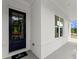 Close up of a front porch featuring a black front door and white brick exterior at 3548 Cedarvale Ct, Powder Springs, GA 30127