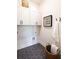 A well-lit laundry room is equipped with cabinets, hooks and a decorative art piece at 3548 Cedarvale Ct, Powder Springs, GA 30127