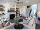 Bright and airy living room with white brick fireplace, floating shelves, and modern furnishings at 3548 Cedarvale Ct, Powder Springs, GA 30127