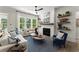 Cozy living room with a fireplace, lots of windows, and comfortable seating at 3548 Cedarvale Ct, Powder Springs, GA 30127