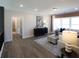 Bright living room features hardwood floors, neutral walls and large windows with a decorative area rug at 3548 Cedarvale Ct, Powder Springs, GA 30127