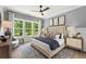 Serene main bedroom with a plush bed, natural light, and stylish decor at 3548 Cedarvale Ct, Powder Springs, GA 30127