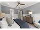 Relaxing main bedroom features soft colors, a ceiling fan, and hardwood floors at 3548 Cedarvale Ct, Powder Springs, GA 30127