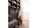 Welcoming mudroom featuring storage, seating, and a view into the open kitchen at 3548 Cedarvale Ct, Powder Springs, GA 30127
