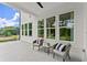 Covered outdoor patio with seating provides a relaxing space for enjoying the outdoors at 3548 Cedarvale Ct, Powder Springs, GA 30127