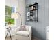 Stylish sitting area with a comfortable chair, unique shelving, and a bright window at 3548 Cedarvale Ct, Powder Springs, GA 30127