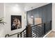 Modern staircase with dark wood and metal railing and an abstract art display at 3548 Cedarvale Ct, Powder Springs, GA 30127