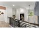 Modern staircase featuring dark wood and metal railings, and hanging light fixture at 3548 Cedarvale Ct, Powder Springs, GA 30127