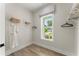 Bright walk-in closet featuring built-in shelving, a window, and light wood floors at 3548 Cedarvale Ct, Powder Springs, GA 30127